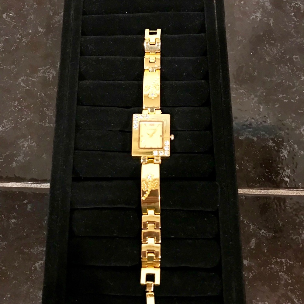 Pak Fook Goldstone watch w/floral-crystal accents.